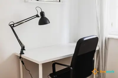 a desk with a black lamp and a chair at The Hideaway of Cádiz by livework in Cádiz