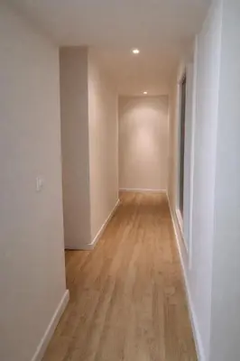 an empty hallway of an empty apartment with wood floors at Rosario by Gades Gestión in Cádiz