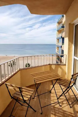 a balcony with a table and chairs and the ocean at SOTAVENTO Apartment by Cadiz4Rentals in Cádiz