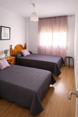 a bedroom with two beds and a window at SOTAVENTO Apartment by Cadiz4Rentals in Cádiz