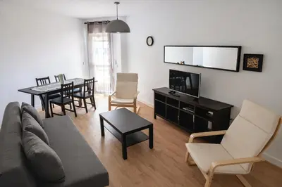a living room with a couch and a dining room at SOTAVENTO Apartment by Cadiz4Rentals in Cádiz