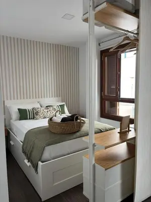 a bedroom with a bed and a desk and a window at Loft Boutique en La Caleta in Cádiz