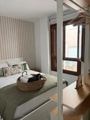 a bedroom with a bed with a basket on it at Loft Boutique en La Caleta in Cádiz