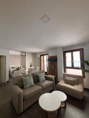 a living room with a couch and a table at Loft Boutique en La Caleta in Cádiz