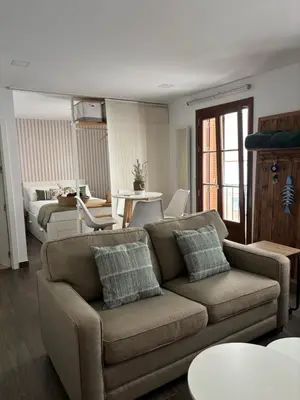 a living room with a couch and a table at Loft Boutique en La Caleta in Cádiz