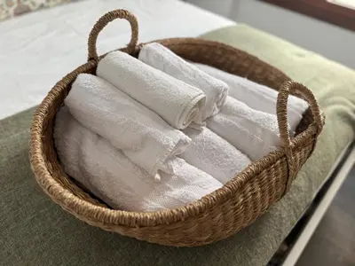 a basket filled with towels on a bed at Loft Boutique en La Caleta in Cádiz