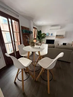 a living room with a white table and chairs at Loft Boutique en La Caleta in Cádiz