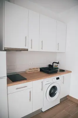 a living room with white walls and a white couch at Apartamento El Quejío in Jerez de la Frontera