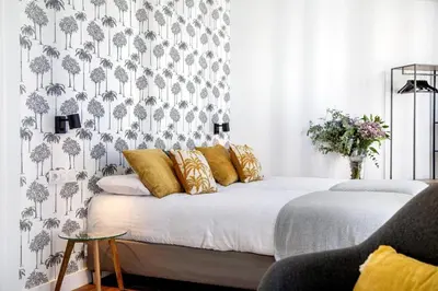 a bedroom with a bed with a black and white wallpaper at Casa MILANO JEREZ 1 in Jerez de la Frontera