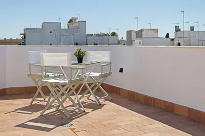 a table and chairs sitting on a roof at Casa MILANO JEREZ 1 in Jerez de la Frontera