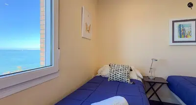 a bedroom with a blue bed and a window at Pacifico Grupo AC Gestion in Cádiz