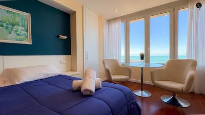 a bedroom with a bed and a table with chairs at Pacifico Grupo AC Gestion in Cádiz