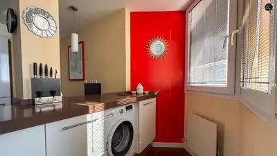 a laundry room with a red wall and a washing machine at Pacifico Grupo AC Gestion in Cádiz