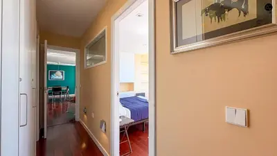 a room with a bedroom with a bed and a mirror at Pacifico Grupo AC Gestion in Cádiz