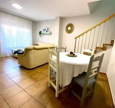 a living room with a table and a couch at Casa Costa Atlantica in Costa Ballena