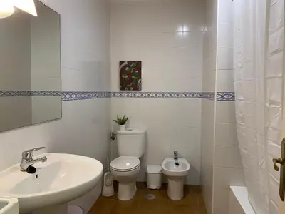 a white bathroom with a sink and a toilet at Casa Costa Atlantica in Costa Ballena