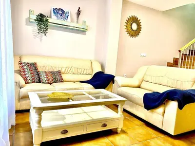 a living room with two couches and a coffee table at Casa Costa Atlantica in Costa Ballena