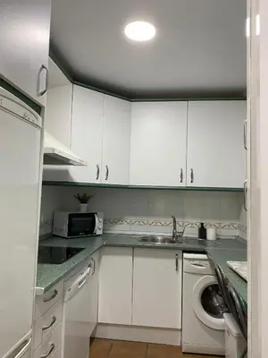 a kitchen with a sink and a washing machine at Casa Costa Atlantica in Costa Ballena