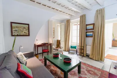 a living room with a couch and a table at Duplex de la Botánica de Cádiz in Cádiz