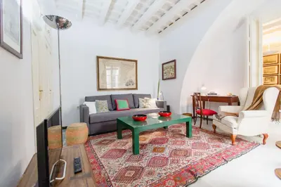 a living room with a couch and a table at Duplex de la Botánica de Cádiz in Cádiz
