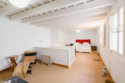 a large white room with two beds in it at Duplex de la Botánica de Cádiz in Cádiz