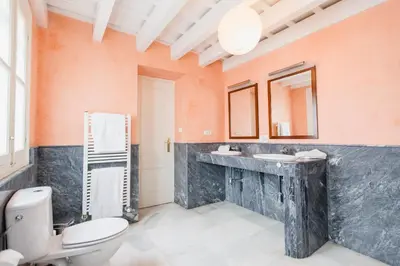 a bathroom with a toilet and a sink at Duplex de la Botánica de Cádiz in Cádiz