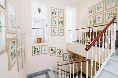 a staircase in a home with art on the walls at Duplex de la Botánica de Cádiz in Cádiz