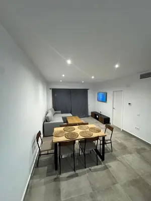 a dining room with a wooden table and chairs at Reserva de Confianza Bahía Sur in San Fernando