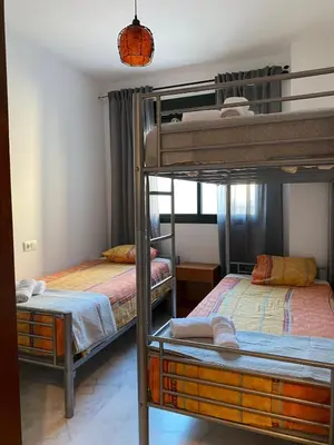 a room with two bunk beds and a room with another bed at Piso en el Centro de Sanlucar in Sanlúcar de Barrameda