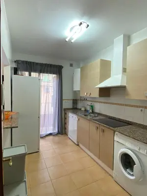 a kitchen with a refrigerator and a washer and dryer at Piso en el Centro de Sanlucar in Sanlúcar de Barrameda