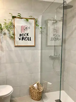 a bathroom with a shower with a toilet and a picture at Casa Salinera Valdelagrana Cádiz - Playa - Ideal para familias in El Puerto de Santa María