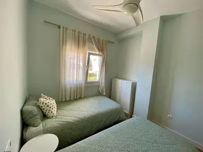 a bedroom with a bed and a window at Casa Salinera Valdelagrana Cádiz - Playa - Ideal para familias in El Puerto de Santa María