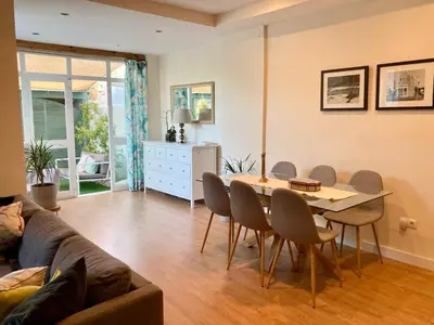 a living room with a couch and a table and chairs at Casa Salinera Valdelagrana Cádiz - Playa - Ideal para familias in El Puerto de Santa María