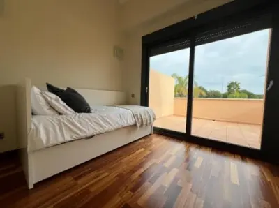 a bedroom with a bed and a large sliding glass door at New Golf Villa and Pool - Families Only in Barrio de Jarana