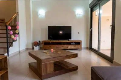 a living room with a coffee table and a flat screen tv at New Golf Villa and Pool - Families Only in Barrio de Jarana