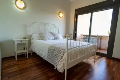 a bedroom with a white bed and a window at New Golf Villa and Pool - Families Only in Barrio de Jarana