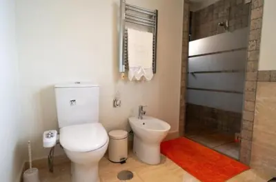 a bathroom with a toilet and a shower at New Golf Villa and Pool - Families Only in Barrio de Jarana