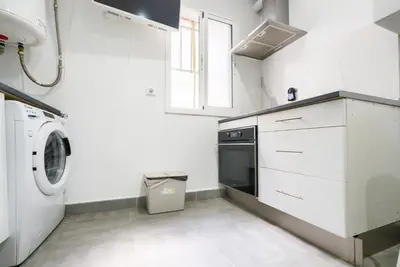 a white laundry room with a washer and dryer at Apartamento Plaza Falla Caleta in Cádiz