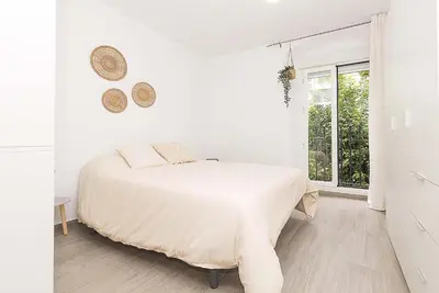 a white bedroom with a bed and a window at El Mirador de Arcos in Arcos de la Frontera