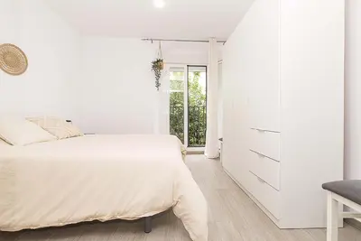 a white bedroom with a bed and a dresser at El Mirador de Arcos in Arcos de la Frontera