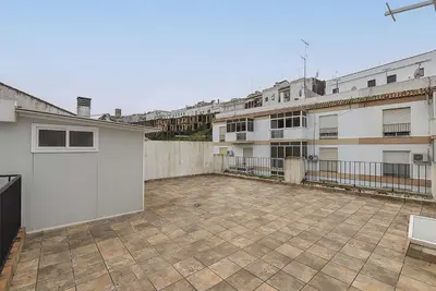 an empty patio in a building with buildings at El Mirador de Arcos in Arcos de la Frontera