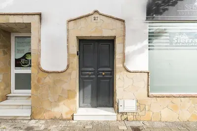 a black door on the side of a building at El Mirador de Arcos in Arcos de la Frontera