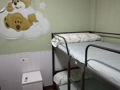 a room with two bunk beds with a teddy bear on a cloud at En el centro de todo in Puerto Real
