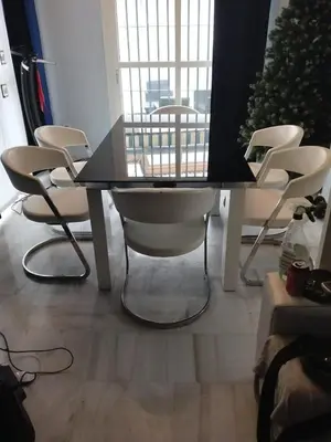 a table and chairs in a room with a christmas tree at En el centro de todo in Puerto Real