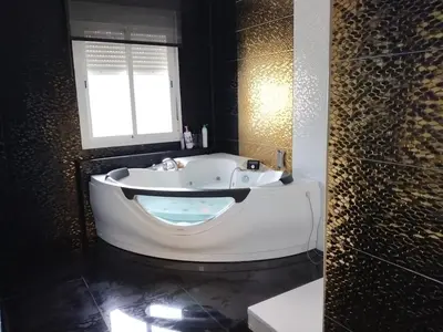 a bath tub in a bathroom with a window at En el centro de todo in Puerto Real
