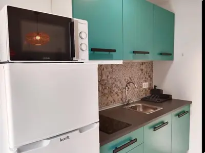 a kitchen with a microwave on top of a refrigerator at Puerta del Sol Jerez in Jerez de la Frontera