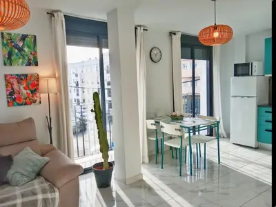 a living room with a table and a dining room at Puerta del Sol Jerez in Jerez de la Frontera