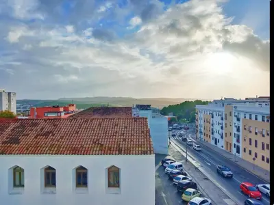 a view of a city with cars parked on a street at Puerta del Sol Jerez in Jerez de la Frontera