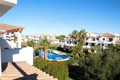 a view from the balcony of a resort with a swimming pool at Ático, El Refugio de Sancti Petri in Novo Sancti Petri