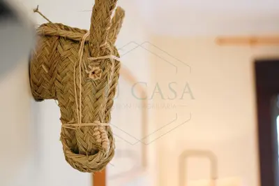 a cross made out of rope on a wall at Ático, El Refugio de Sancti Petri in Novo Sancti Petri